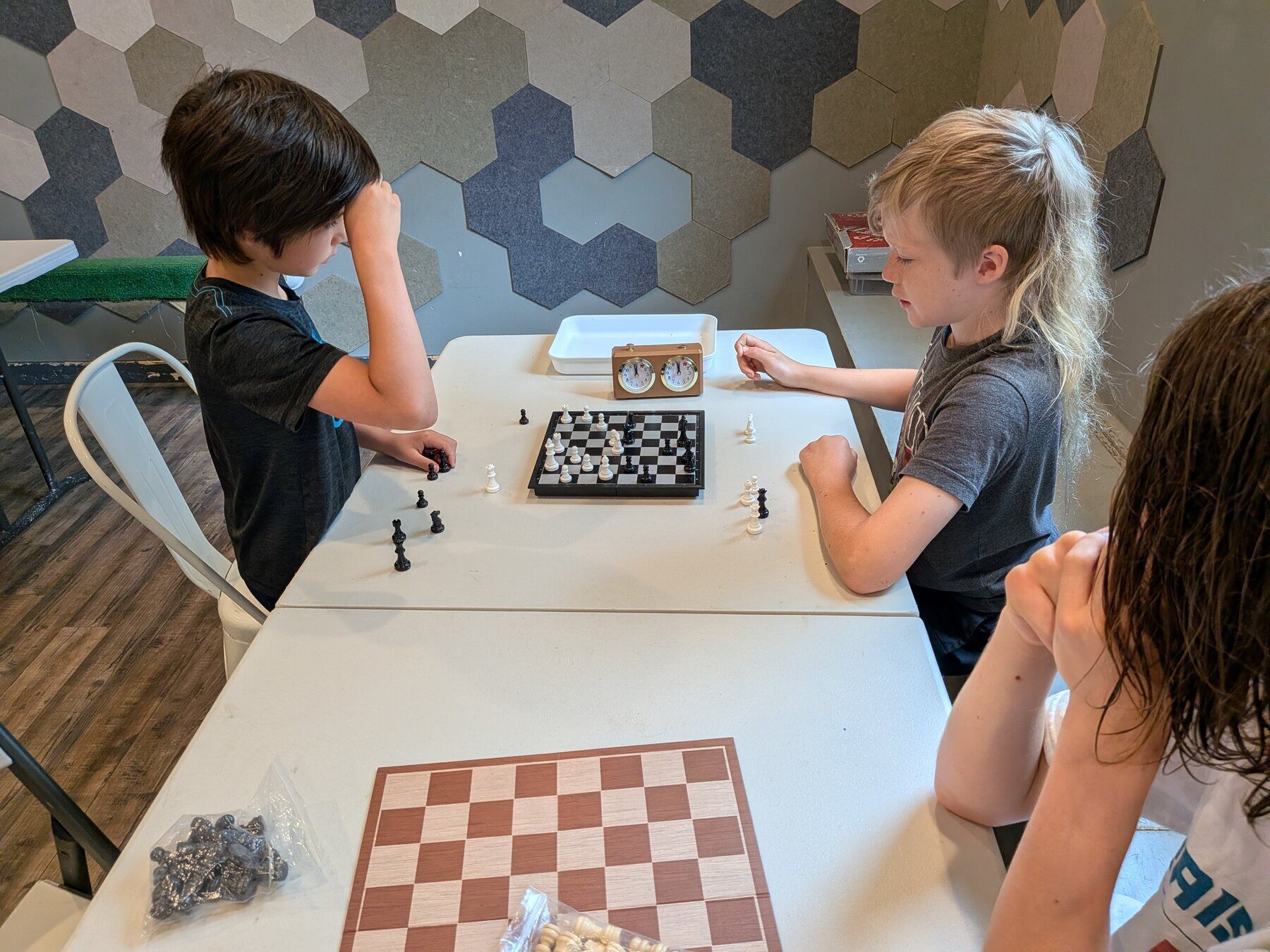 A chess game in progress at a long table