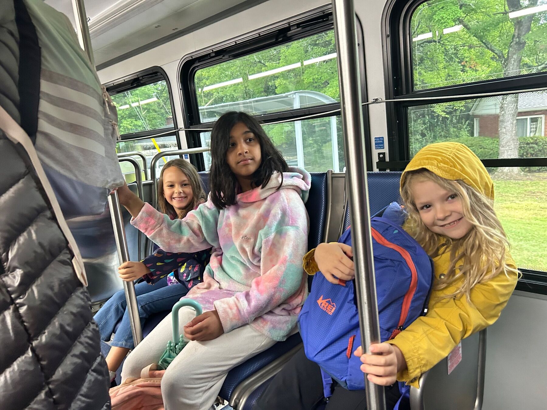 Kids laughing together on a city bus