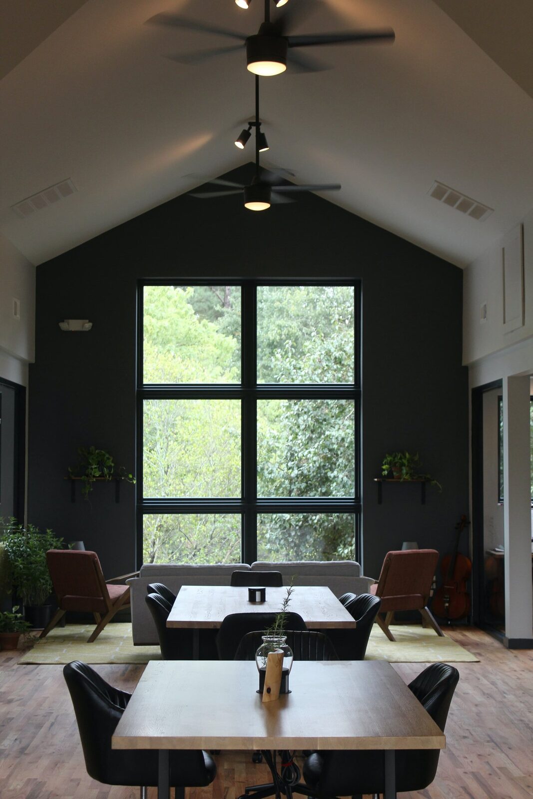 The main coworking room: tall windows, a long table and lounge chairs under a vaulted ceiling