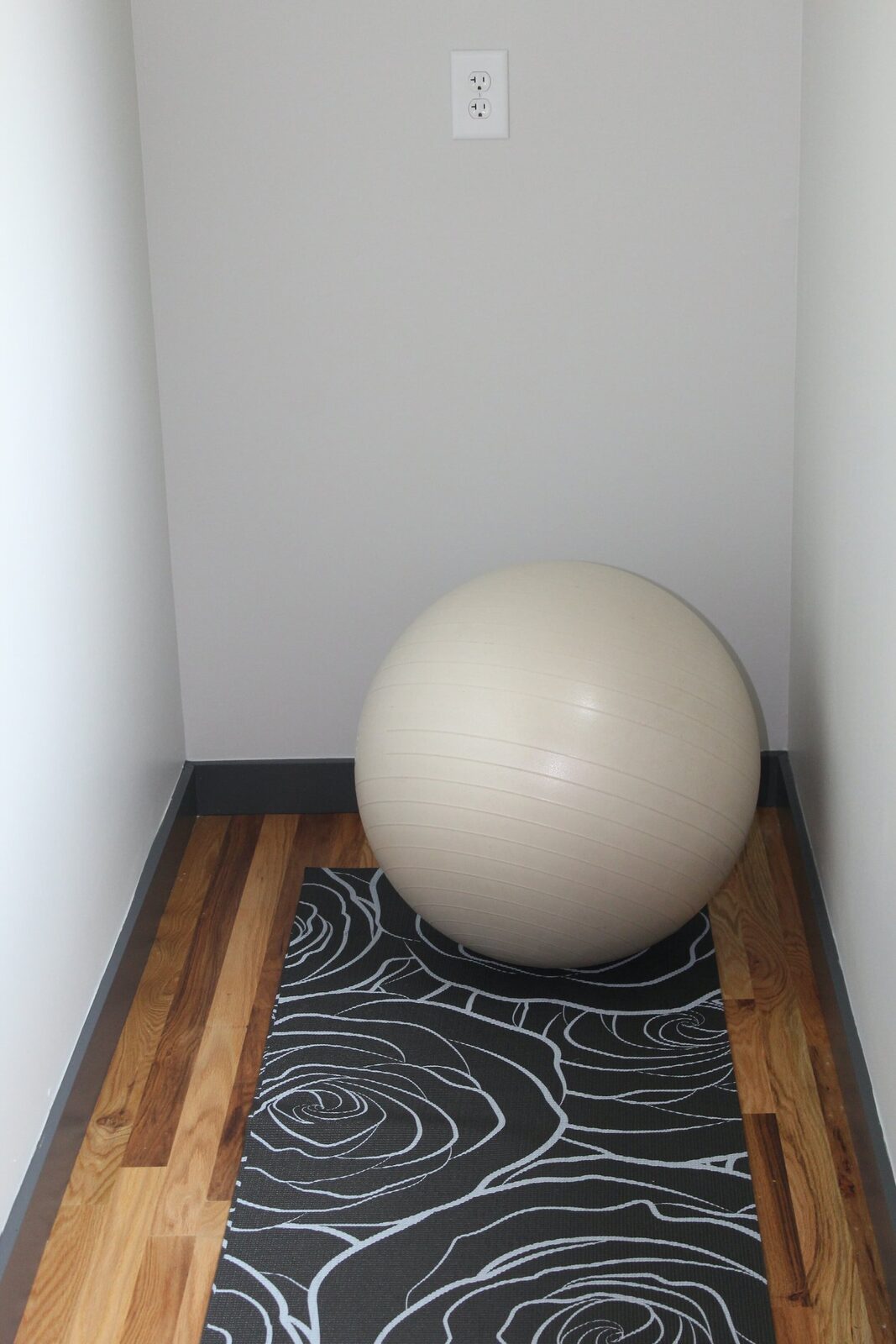 A quiet nook with a yoga mat and an exercise ball
