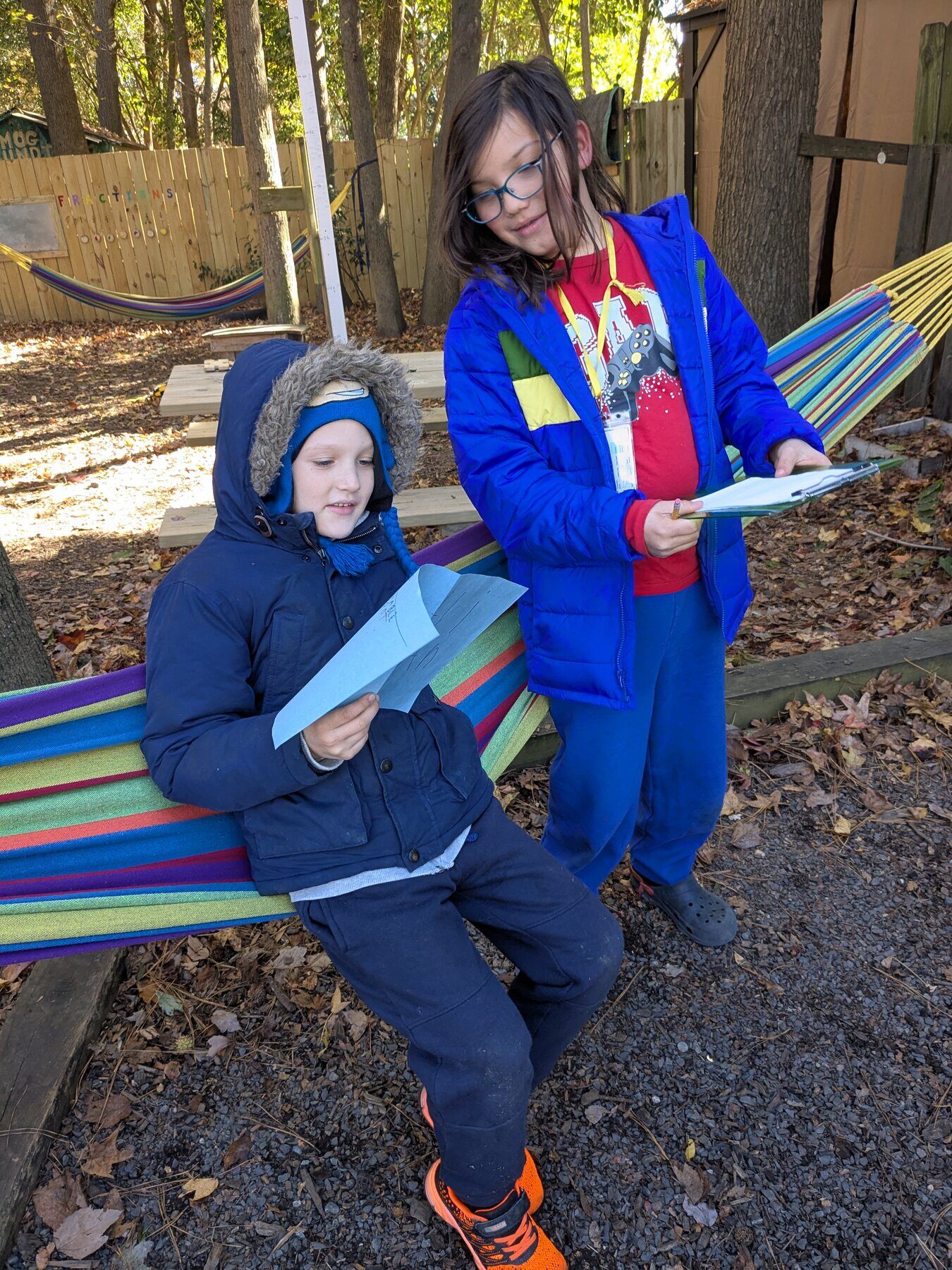 Two kids reading in a hammock
