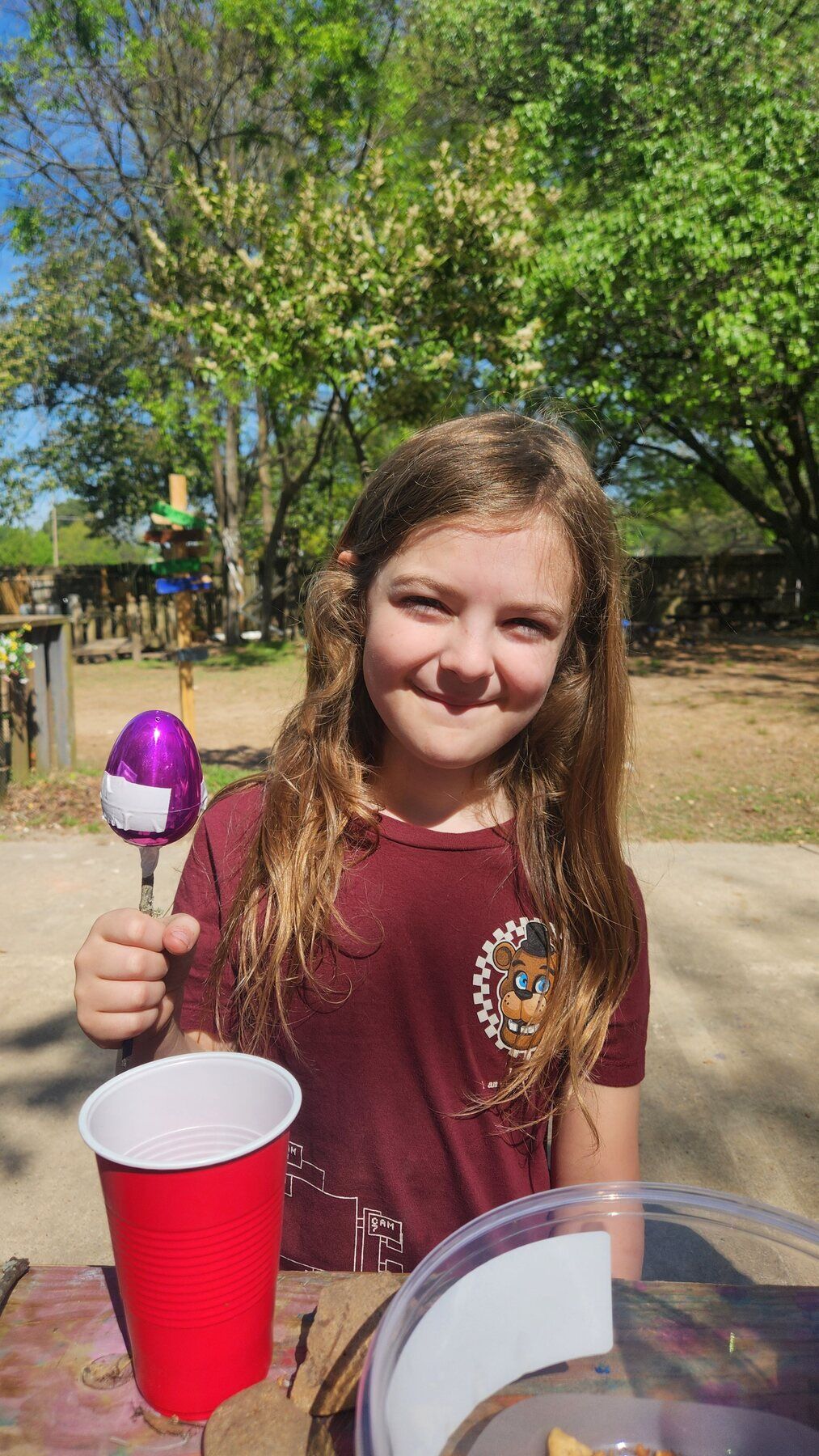 A kid showing off a homemade shaker