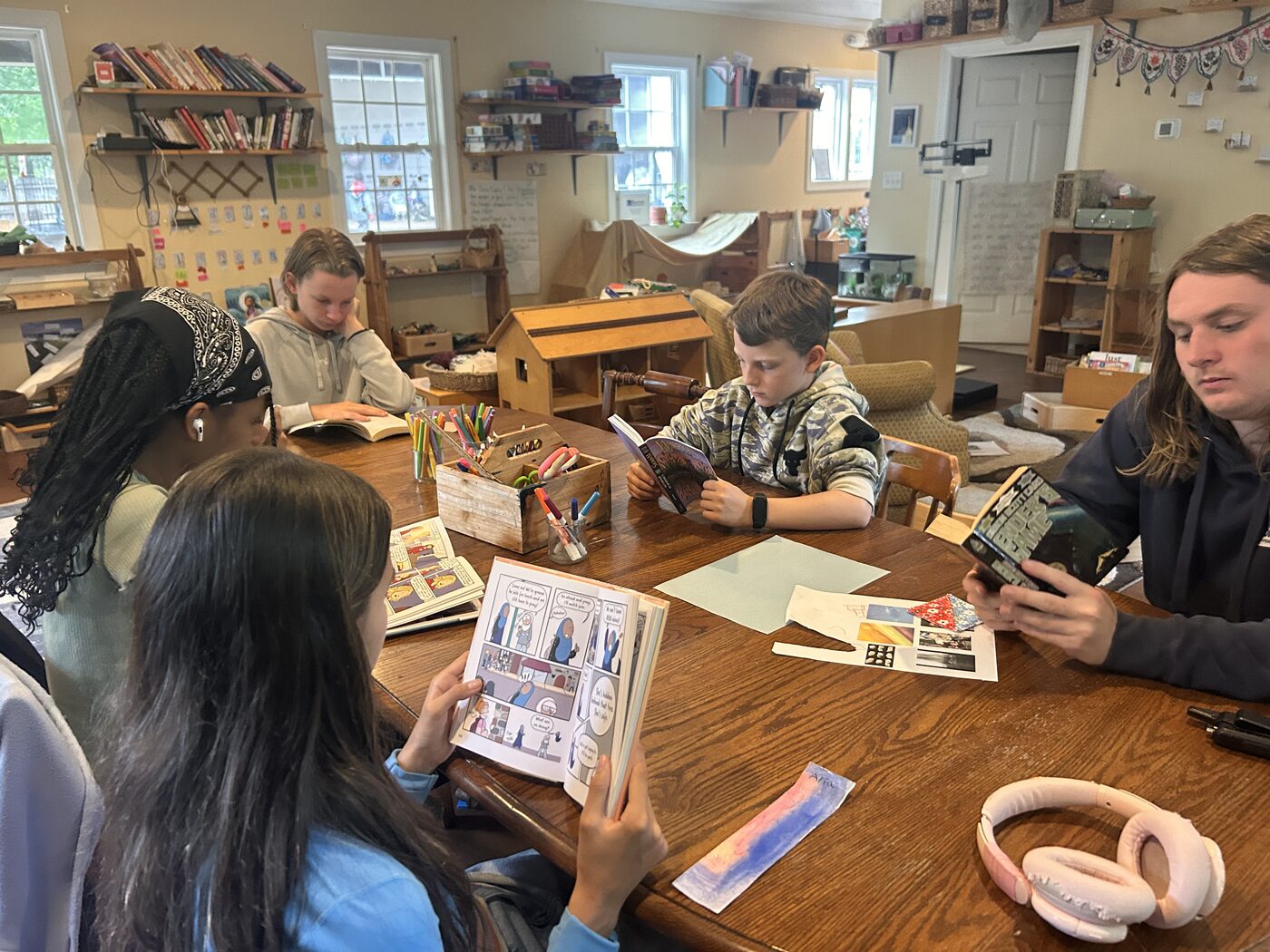Kids working on their own projects around a long table