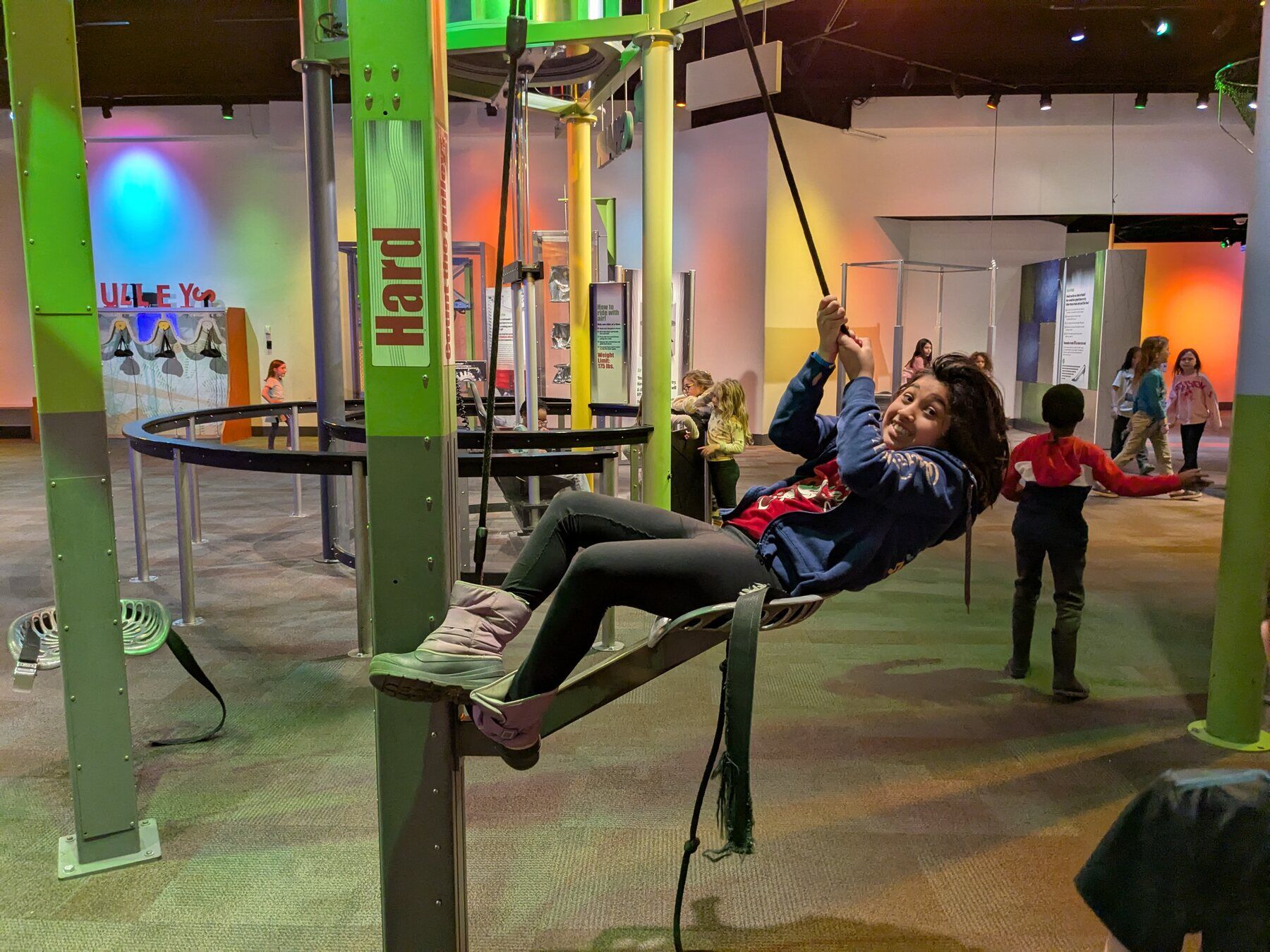 Kids climbing on a net at the science museum